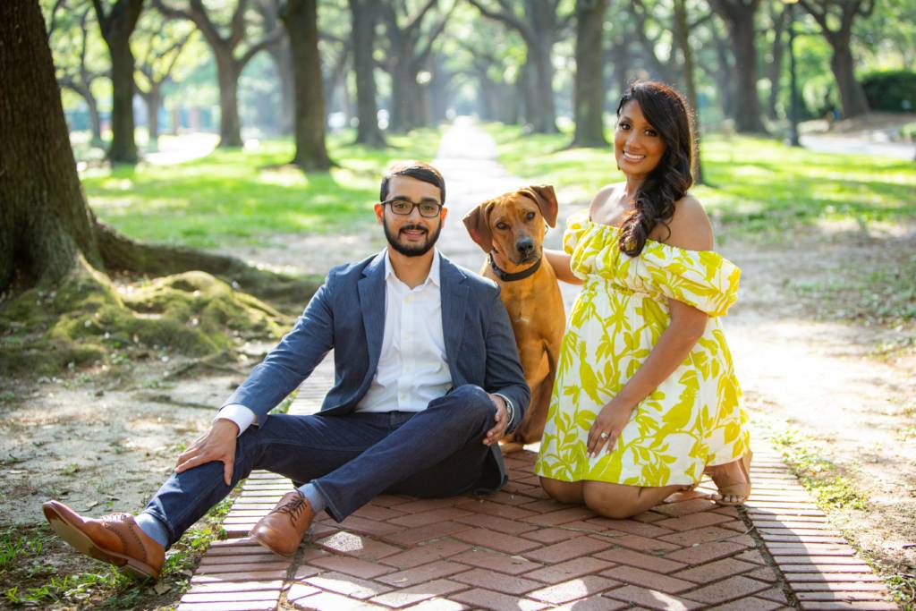 Houston family photographer capturing an outdoor maternity portrait of a couple with their dog