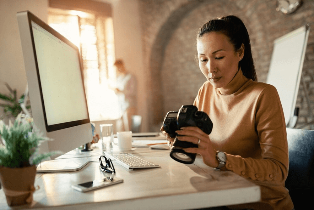 female photographer culling photos for editing