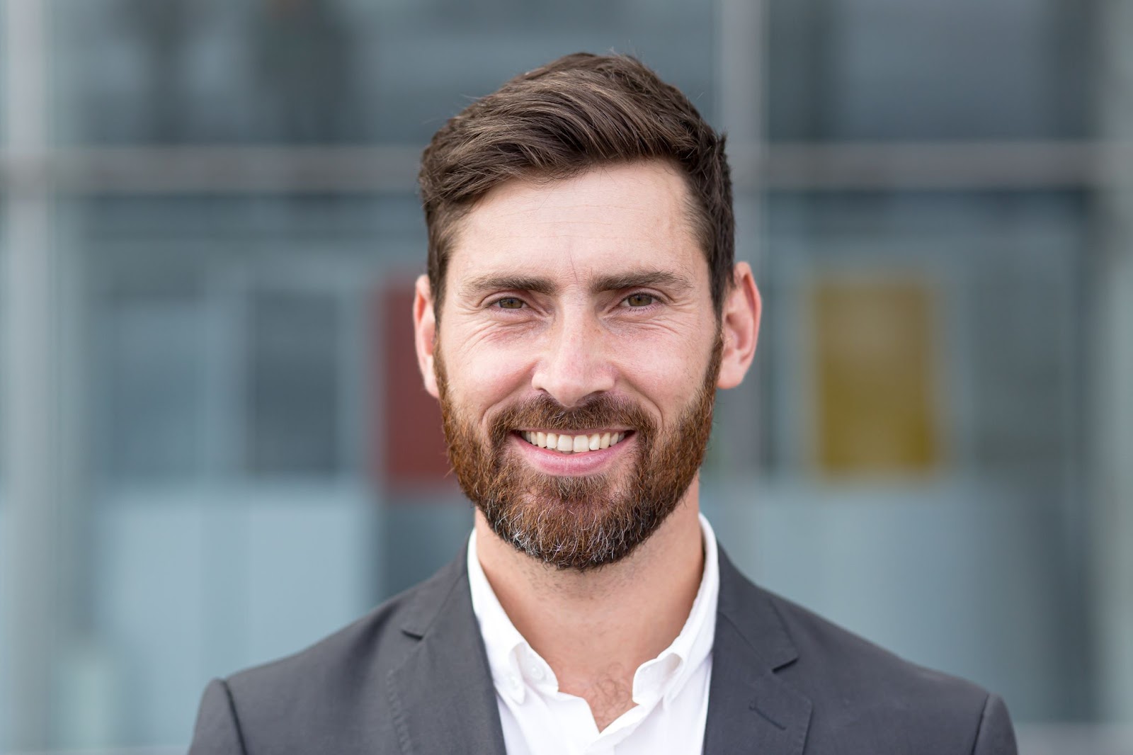 a professional headshot of a man in a suit