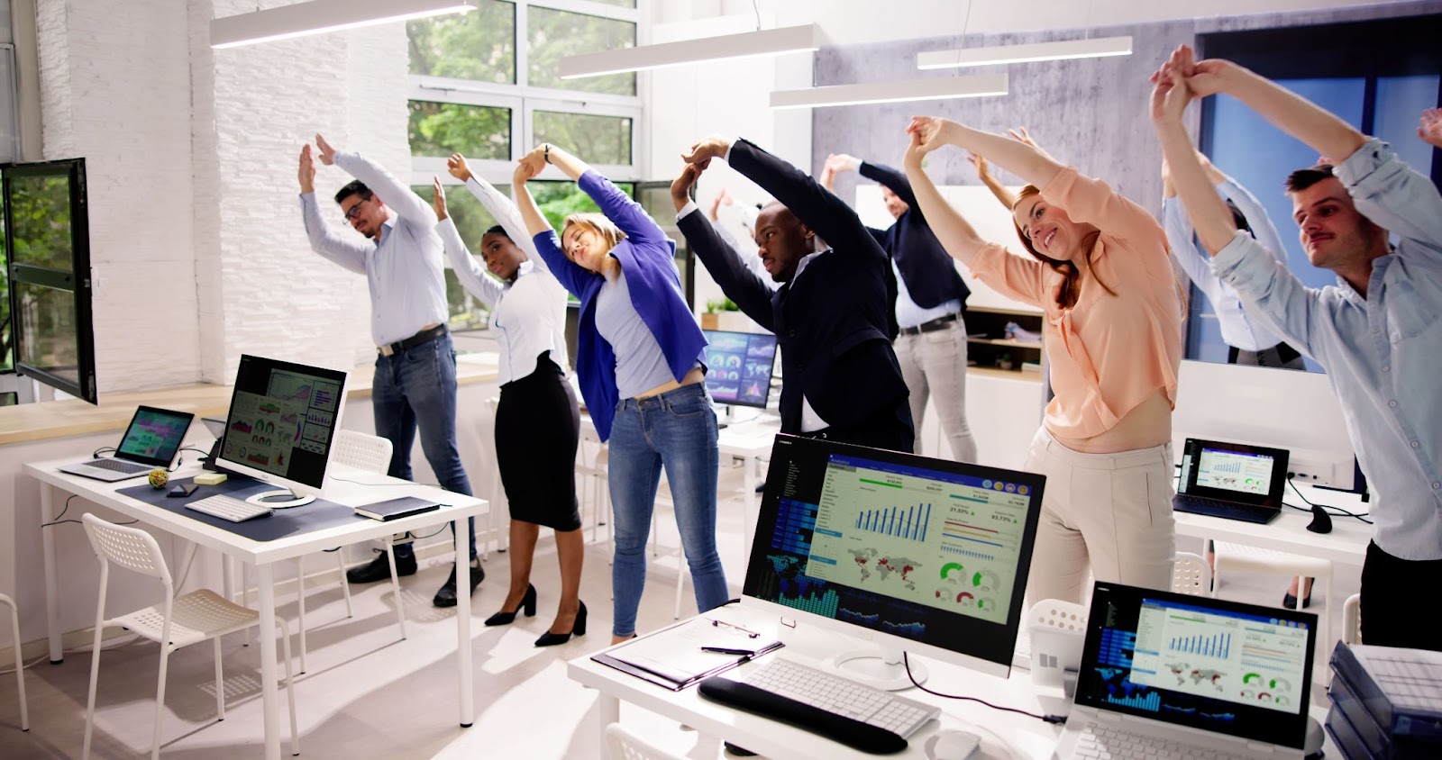 a group of employees doing stretching exercises at the office