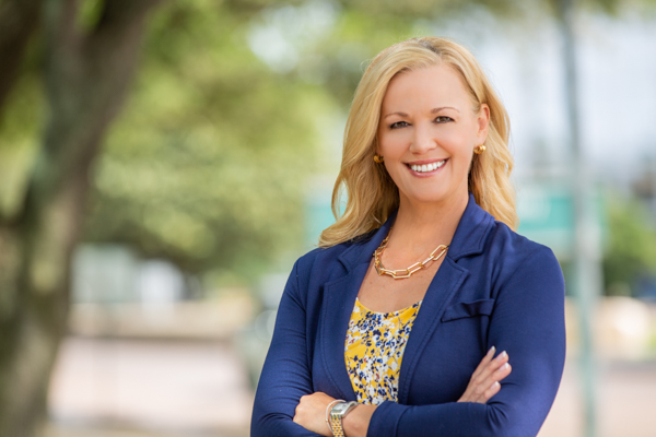Professional corporate headshot of a man taken outdoors by a headshot photographer in Houston, featuring natural light and a polished business look.
