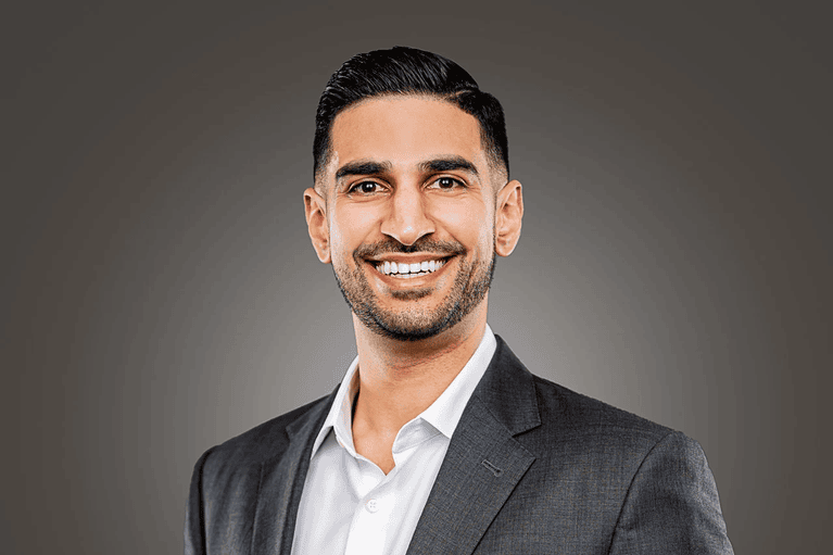 Smiling businessman in a suit for professional headshots near Houston.