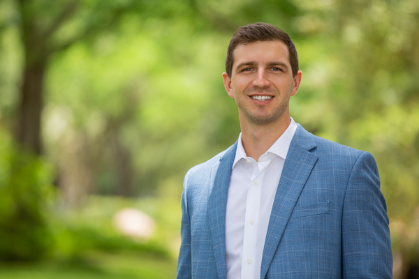 Professional outdoor corporate headshot of a man in blue suit by Pixel Studio Productions in Houston