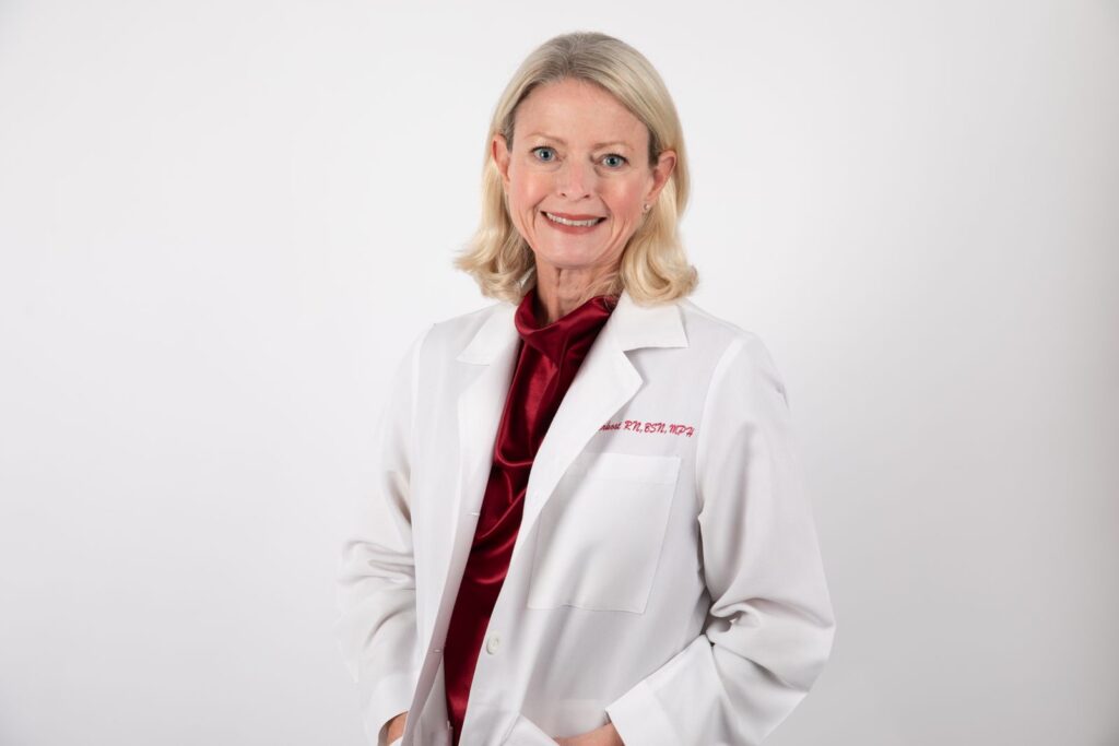 Medical headshots Houston — smiling female physician in a white coat, Pixel Studio Productions