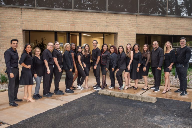 Group of professionals in black attire outside office building in Houston.