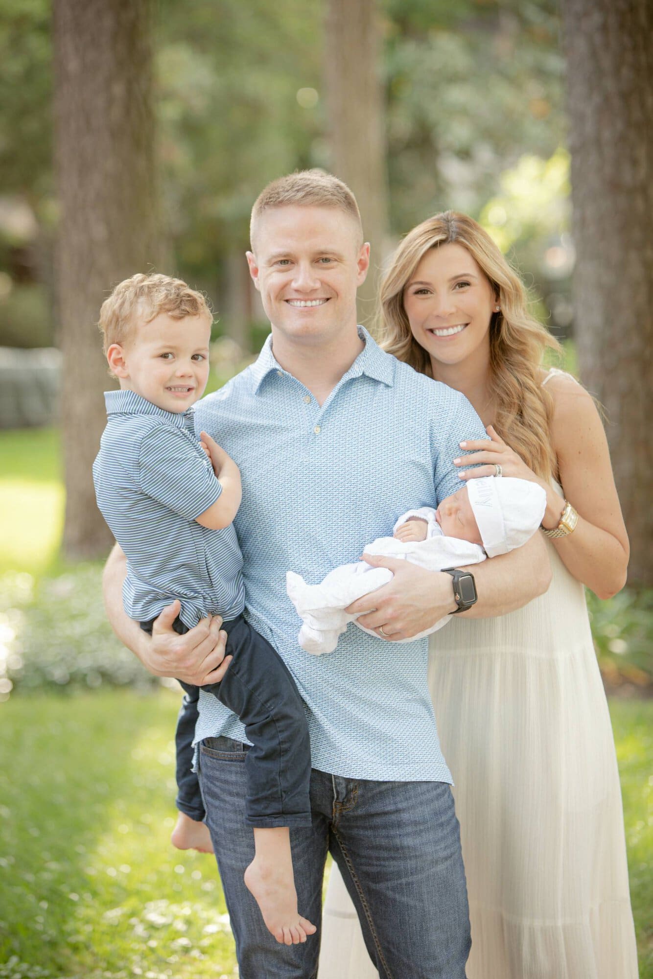 Happy family with two children outdoors in Houston park.
