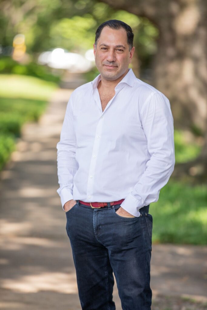 dating profile photographer in Houston capturing an outdoor portrait of a man in a white shirt for dating apps