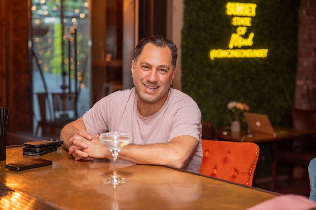 dating profile photographer in Houston capturing a relaxed bar portrait of a man with a cocktail