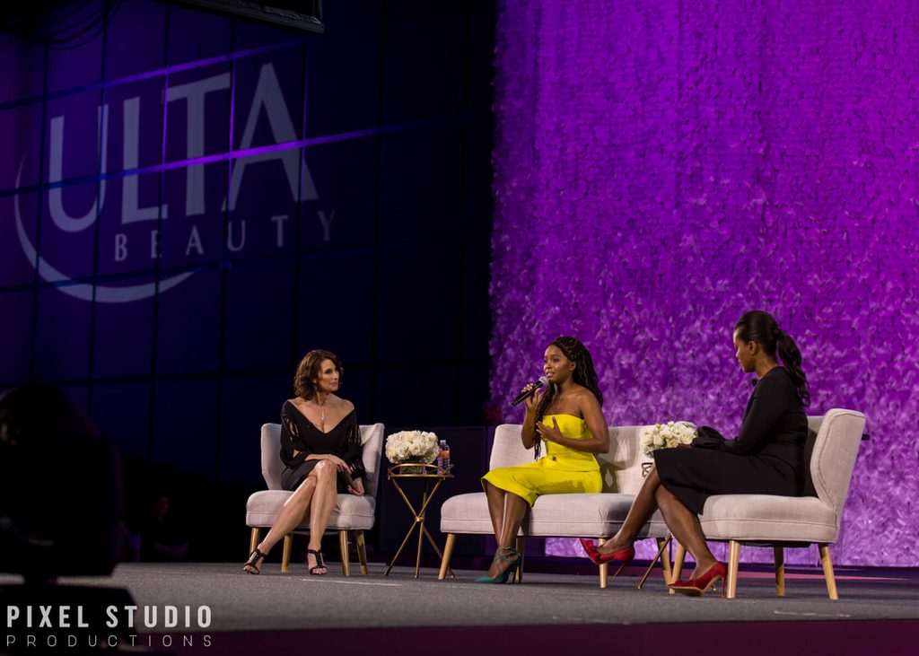 Women speaking on stage during a corporate event in Houston.