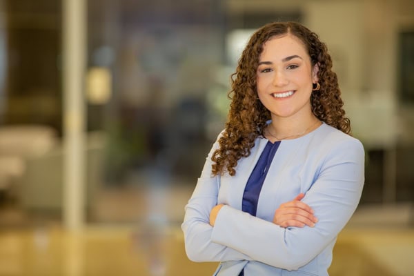 Smiling woman in professional attire for career headshots.