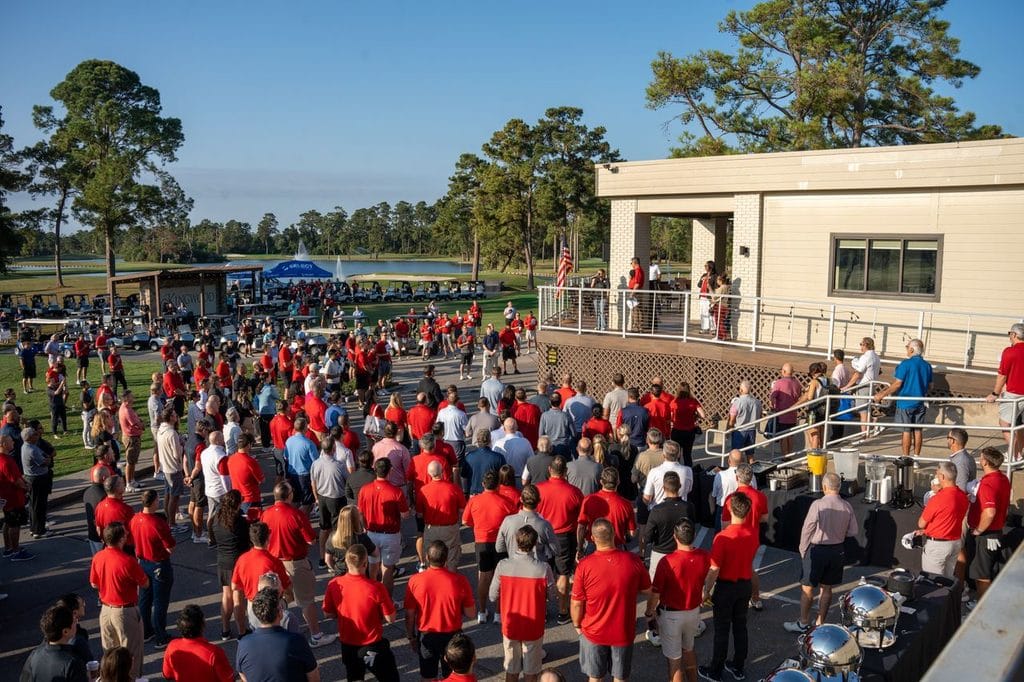 Crowd of people gathered outside a conference center in Houston during a multi-day event.