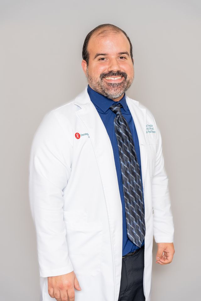Doctor headshot Houston — male physician in a white coat and tie, Pixel Studio Productions