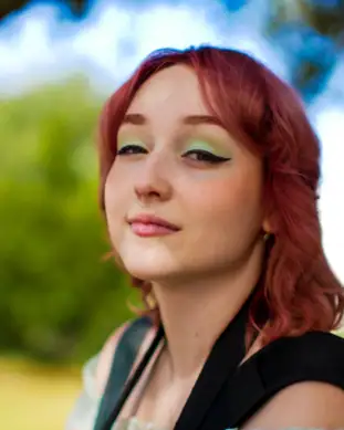 Anna Rodionova, Pixel Studio Productions videographer, outdoor portrait with red hair and green eyeshadow