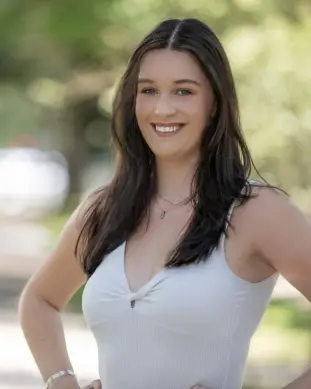 Sadie, Pixel Studio Productions lead photographer, outdoor portrait in a white top