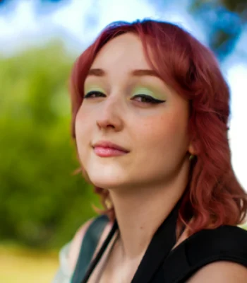 Anna Rodionova, Pixel Studio Productions videographer, outdoor portrait with red hair and green eyeshadow