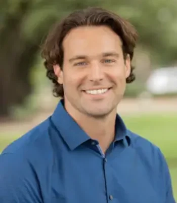 Ken, Pixel Studio Productions videographer, outdoor portrait in a blue button-up shirt