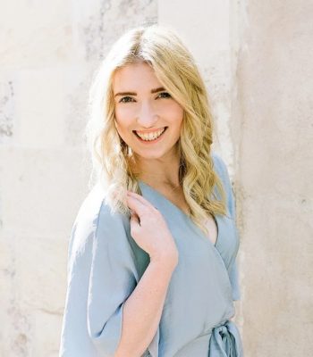 Alicia Yarrish, Pixel Studio Productions team member, outdoor portrait in a light blue wrap top
