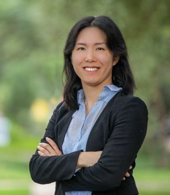 Susan, Pixel Studio Productions team member, outdoor portrait in a black blazer and light blue shirt with arms crossed